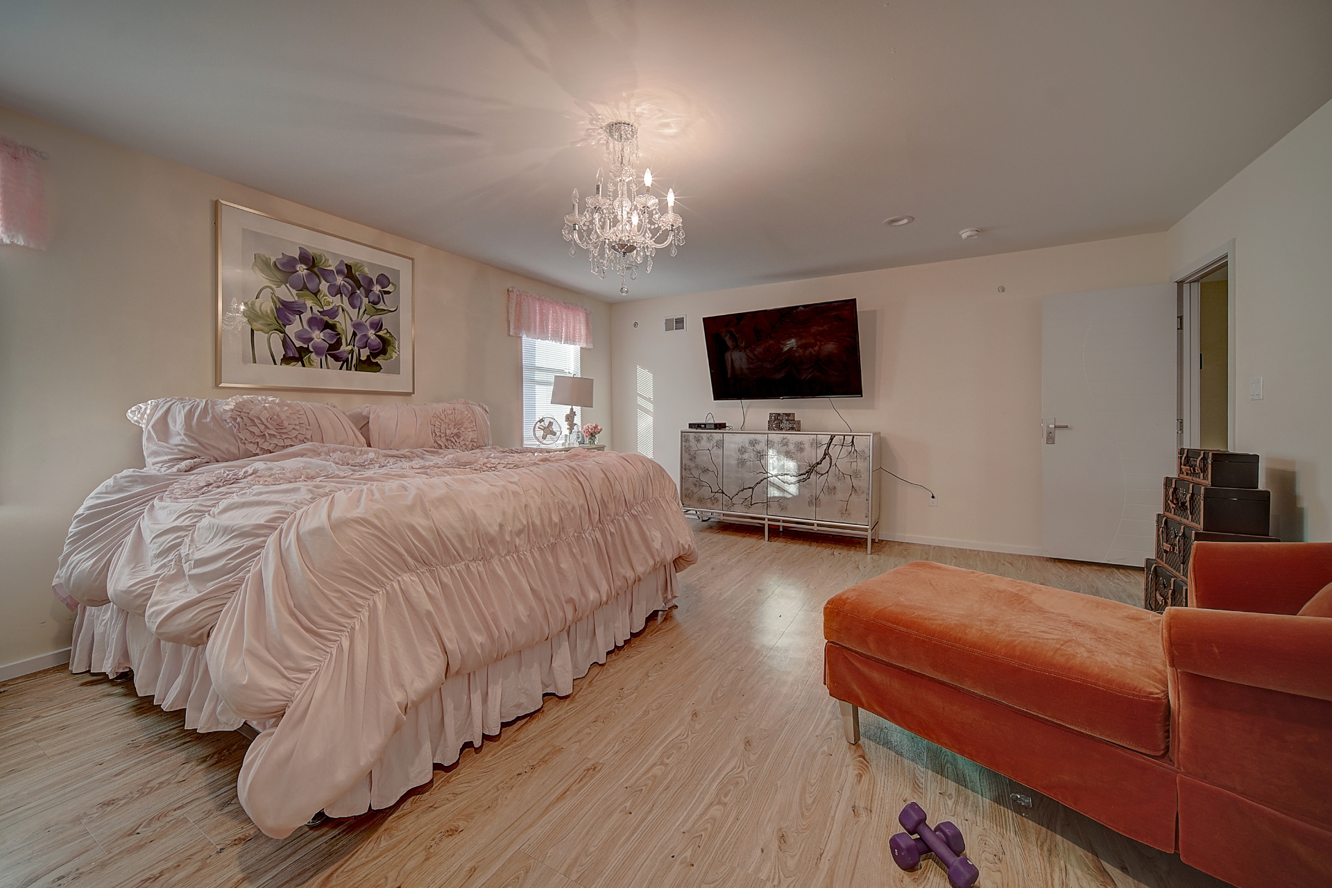 Sunlit bedroom with pink accent wall
